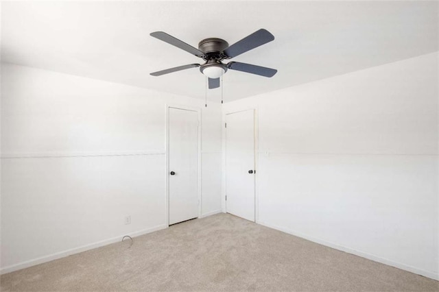 interior space featuring light colored carpet and ceiling fan