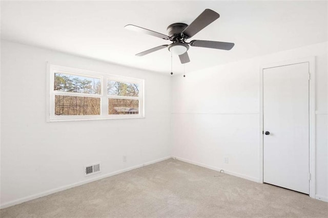 carpeted empty room featuring ceiling fan