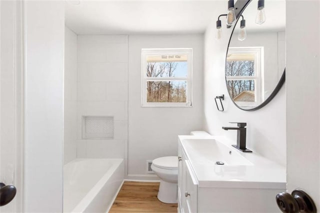 full bathroom with hardwood / wood-style flooring, toilet, vanity, and bathing tub / shower combination