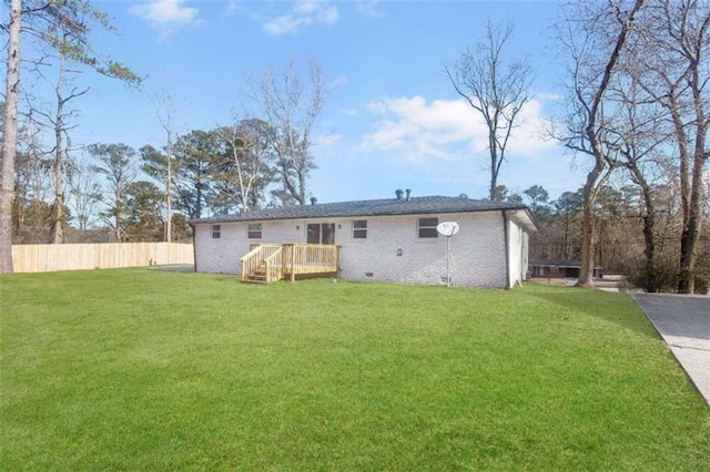 rear view of house with a yard and a deck