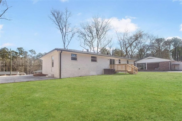 back of house with a lawn and a deck