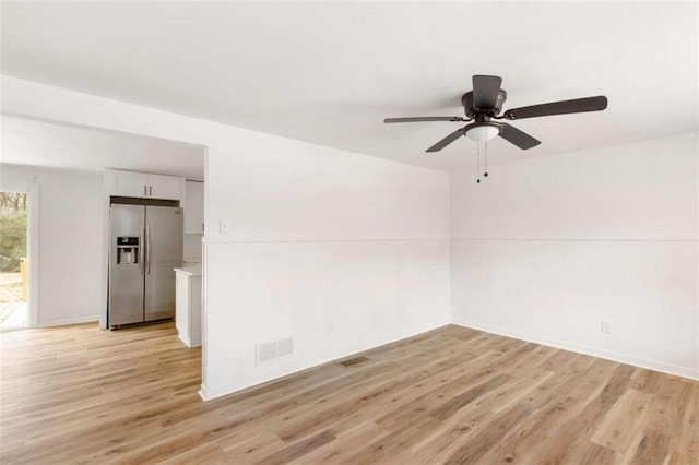 empty room featuring ceiling fan and light wood-type flooring