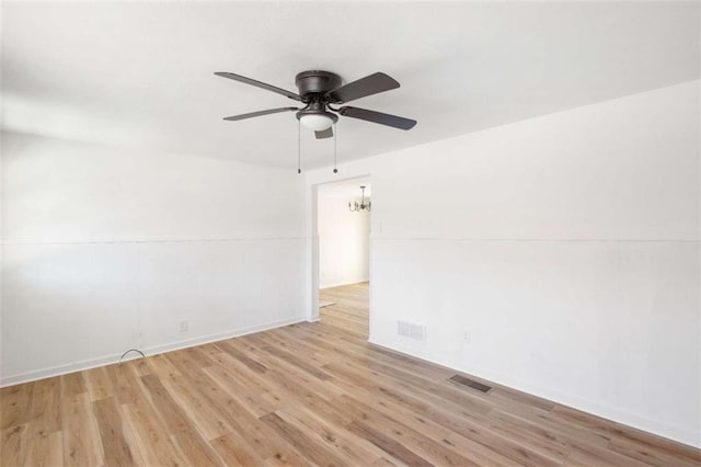 empty room featuring ceiling fan and light wood-type flooring