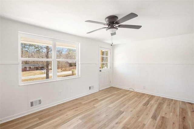 empty room with ceiling fan and light hardwood / wood-style floors