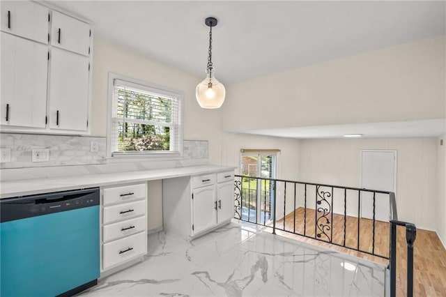 kitchen with dishwasher, light countertops, marble finish floor, and white cabinetry