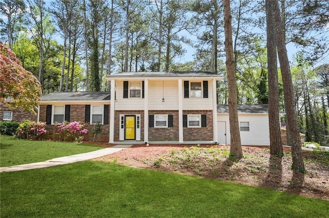 view of front of property with brick siding and a front yard