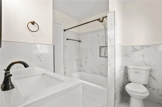 full bathroom with toilet, marble finish floor, a sink, tile walls, and bathing tub / shower combination