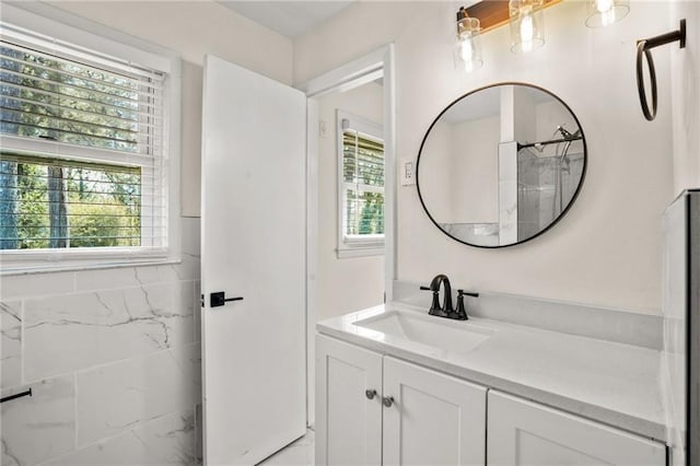 full bath with vanity and a wealth of natural light