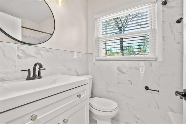 full bathroom with toilet, vanity, tile walls, and walk in shower