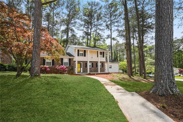 view of front of home with brick siding and a front yard