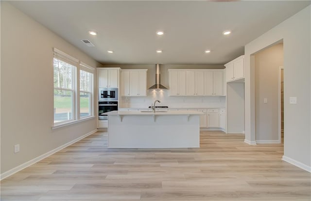 138 Crabbswood Dr, Mcdonough, GA 30253 - kitchen featuring visible vents, wall oven, stainless steel microwave, tasteful backsplash, and wall chimney range hood