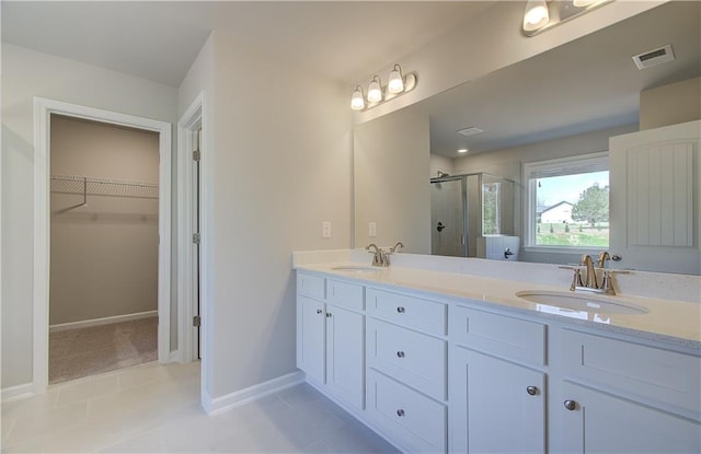 138 Crabbswood Dr, Mcdonough, GA 30253 - full bath with a shower stall, visible vents, a walk in closet, and a sink