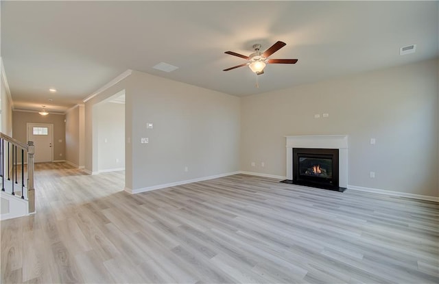 138 Crabbswood Dr, Mcdonough, GA 30253 - unfurnished living room featuring light wood-style flooring, ceiling fan, visible vents, and stairway
