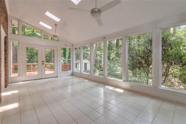 unfurnished sunroom featuring ceiling fan, french doors, and lofted ceiling with skylight