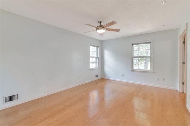 spare room featuring ceiling fan and light hardwood / wood-style flooring