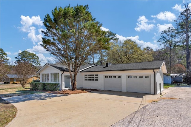 ranch-style home featuring an attached garage and driveway