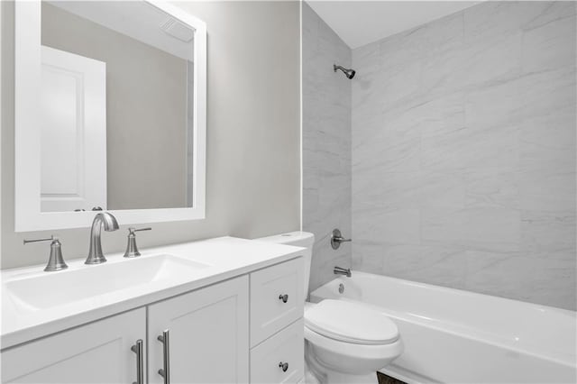 bathroom featuring toilet, shower / washtub combination, and vanity