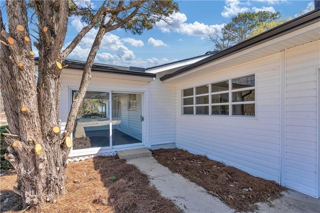 doorway to property featuring solar panels