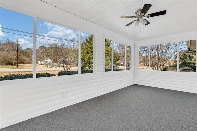 unfurnished sunroom featuring a ceiling fan