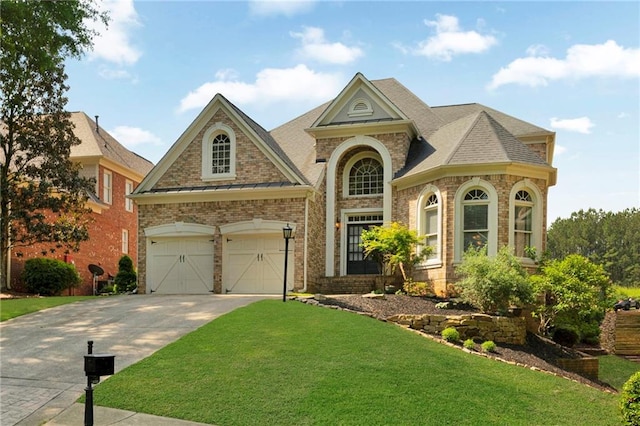 view of front of home with brick siding, a front yard, and concrete driveway