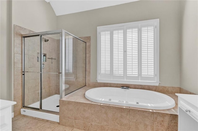 bathroom featuring vanity, a stall shower, tile patterned floors, and a garden tub