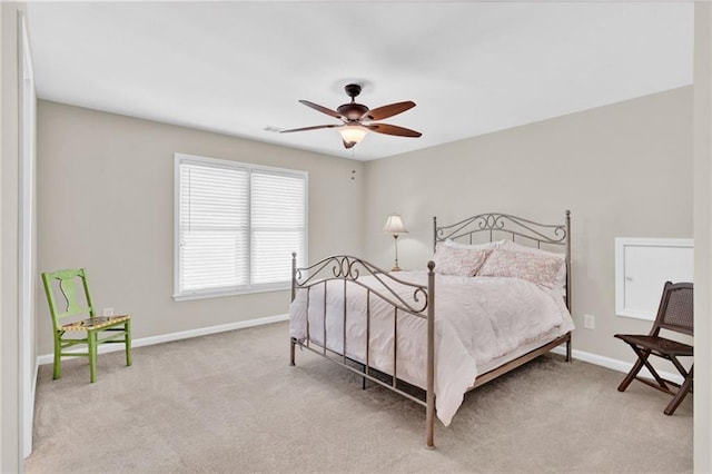 bedroom featuring light colored carpet, baseboards, and ceiling fan