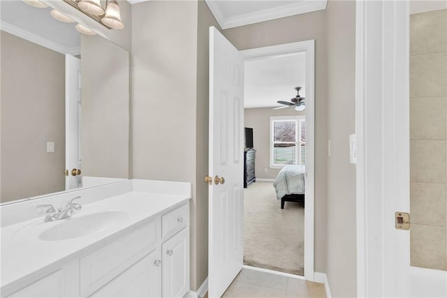 ensuite bathroom featuring connected bathroom, baseboards, ornamental molding, and vanity