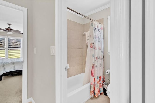 bathroom featuring baseboards, ornamental molding, a ceiling fan, and shower / bath combo