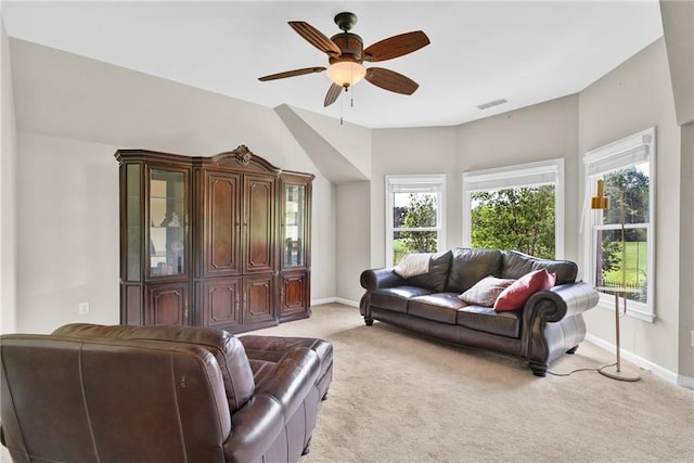 living room featuring light colored carpet, a ceiling fan, baseboards, and visible vents