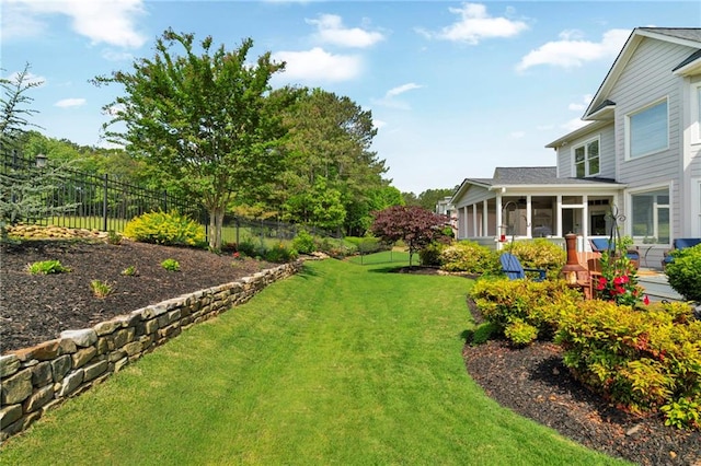 view of yard with a fenced backyard and a sunroom