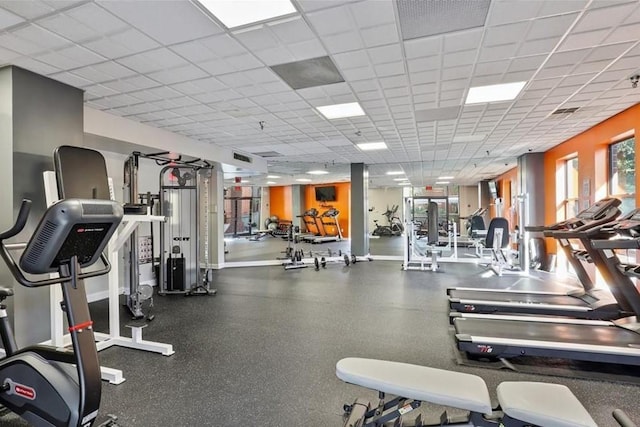 gym with a paneled ceiling