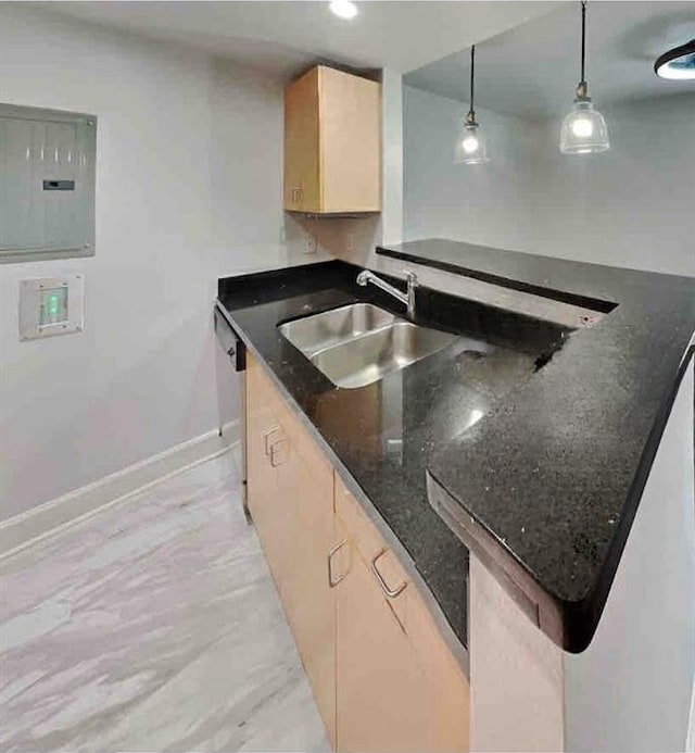 kitchen with electric panel, sink, hanging light fixtures, dark stone countertops, and light brown cabinetry