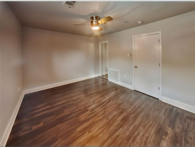 unfurnished room featuring ceiling fan and dark wood-type flooring