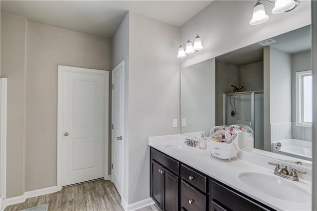 1102 Kingswood Way, Hoschton, GA 30548 - full bath featuring a shower stall, wood finished floors, double vanity, a garden tub, and baseboards