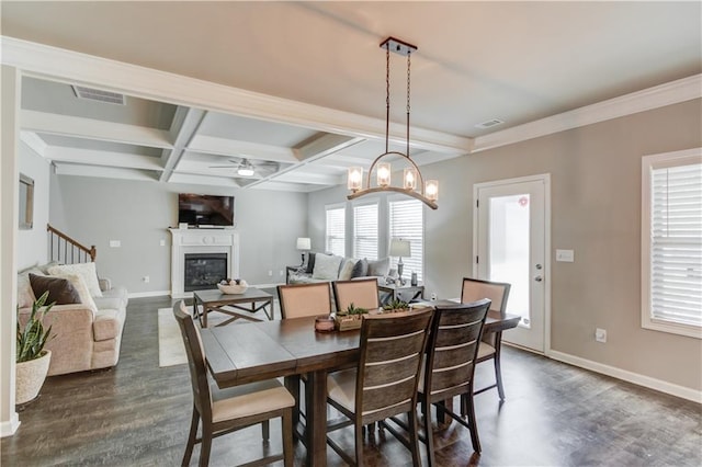 1102 Kingswood Way, Hoschton, GA 30548 - dining area featuring dark wood-style floors, baseboards, ceiling fan, a glass covered fireplace, and coffered ceiling