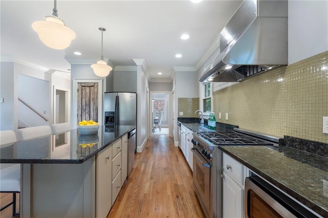 1066 High Point Dr, Atlanta, GA 30306 - kitchen featuring appliances with stainless steel finishes, extractor fan, decorative backsplash, light wood finished floors, and a breakfast bar