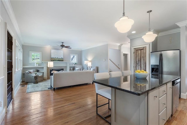 1066 High Point Dr, Atlanta, GA 30306 - kitchen with stainless steel refrigerator with ice dispenser, a ceiling fan, light wood-style flooring, ornamental molding, and hanging light fixtures