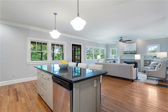 1066 High Point Dr, Atlanta, GA 30306 - kitchen featuring stainless steel dishwasher, a center island, light wood-style flooring, a ceiling fan, and crown molding
