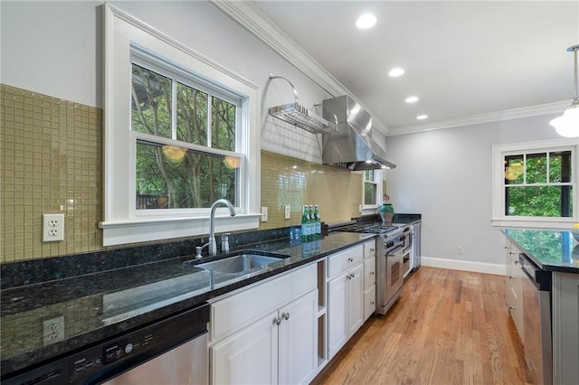 1066 High Point Dr, Atlanta, GA 30306 - kitchen featuring appliances with stainless steel finishes, wall chimney exhaust hood, crown molding, white cabinets, and dark stone counters