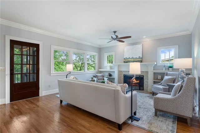 1066 High Point Dr, Atlanta, GA 30306 - living area featuring a fireplace, wood finished floors, ornamental molding, and a ceiling fan