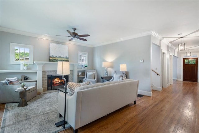 1066 High Point Dr, Atlanta, GA 30306 - living room featuring a brick fireplace, ceiling fan, wood finished floors, and ornamental molding