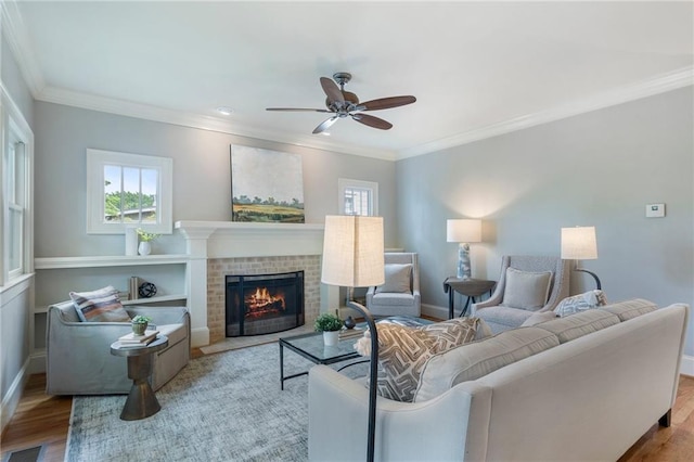 1066 High Point Dr, Atlanta, GA 30306 - living room with ceiling fan, a fireplace, wood finished floors, and ornamental molding