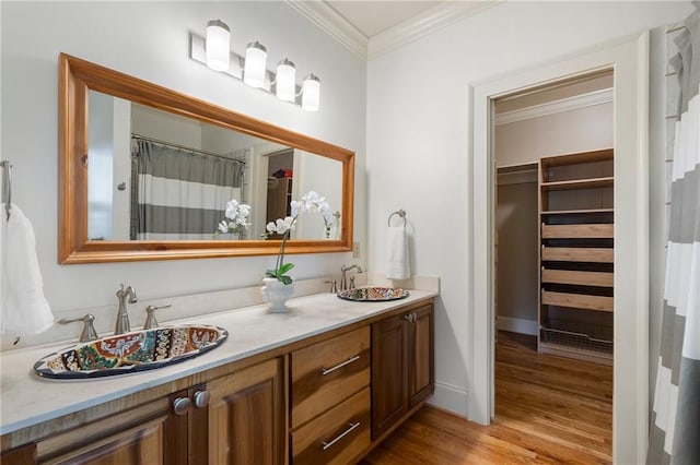 1066 High Point Dr, Atlanta, GA 30306 - full bathroom with ornamental molding, double vanity, wood finished floors, and a spacious closet