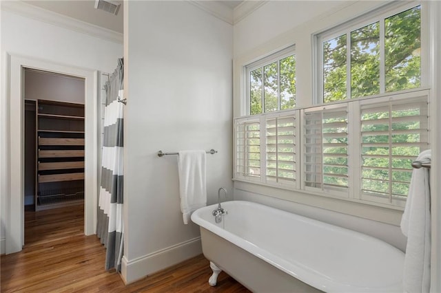 1066 High Point Dr, Atlanta, GA 30306 - full bathroom with ornamental molding, plenty of natural light, wood finished floors, and a freestanding bath