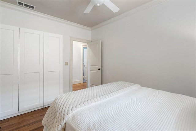 1066 High Point Dr, Atlanta, GA 30306 - bedroom with dark wood-type flooring, ornamental molding, a closet, and ceiling fan