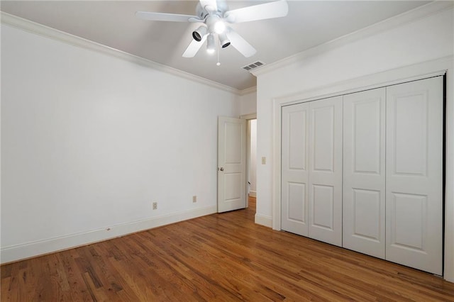 1066 High Point Dr, Atlanta, GA 30306 - unfurnished bedroom featuring ornamental molding, wood finished floors, a ceiling fan, and a closet