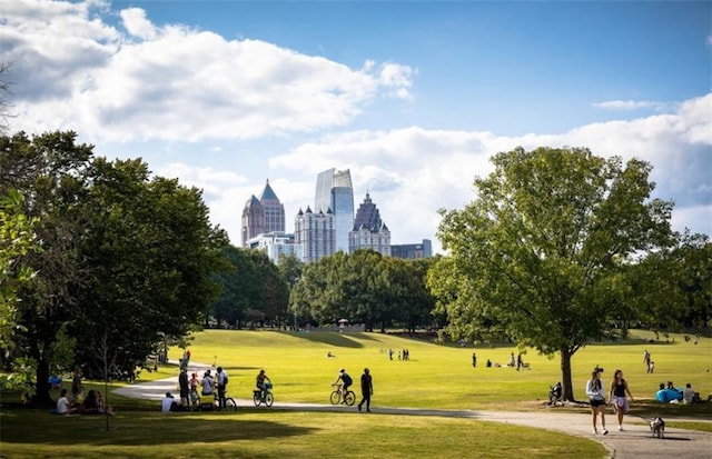 surrounding community featuring a lawn and a view of city