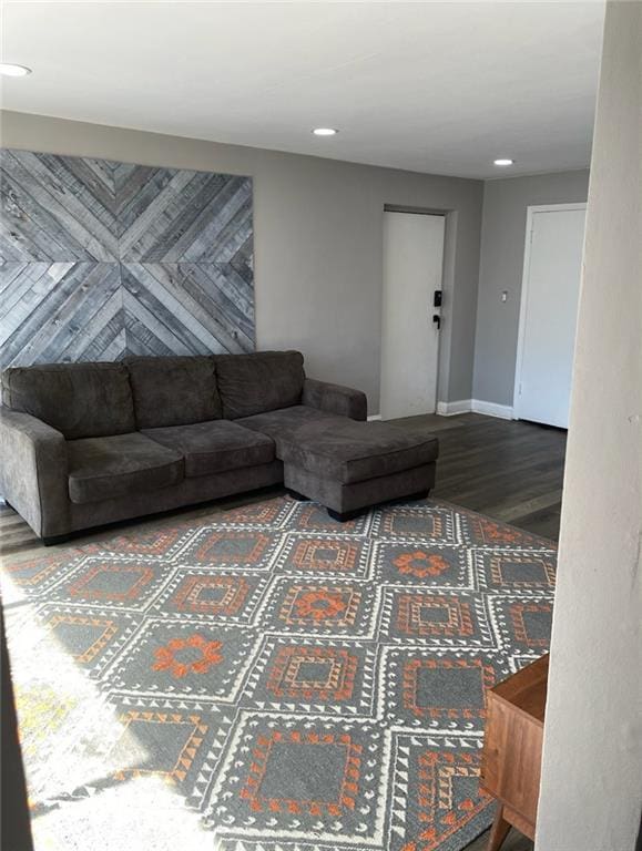 living area with recessed lighting, baseboards, and wood finished floors