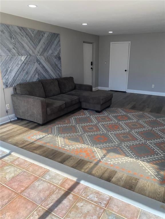 living area featuring recessed lighting, baseboards, and wood finished floors