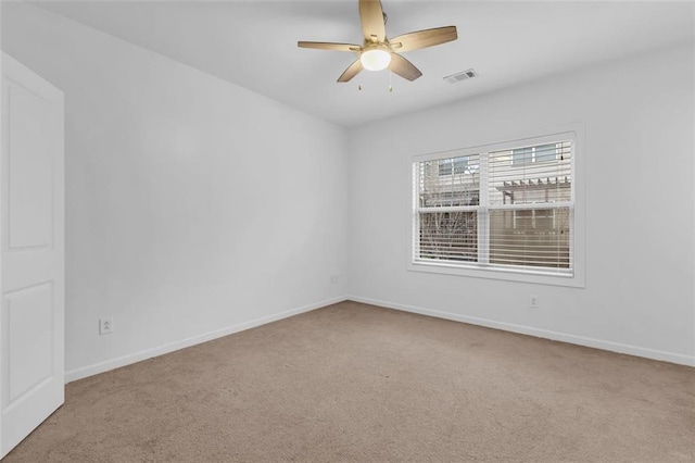 carpeted spare room featuring ceiling fan